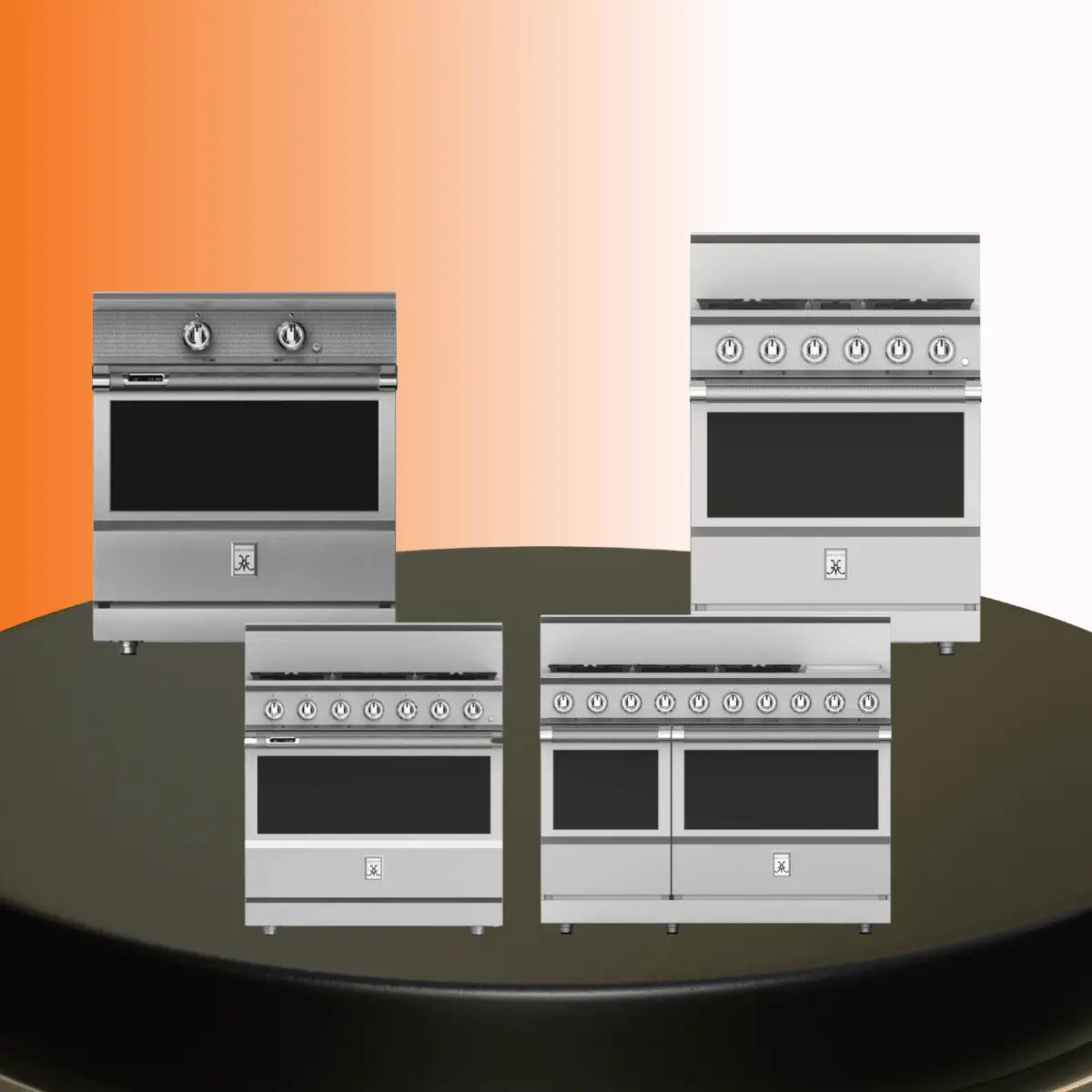 Hestan ranges collection featuring professional stainless steel kitchen ranges with gas burners, control knobs, and oven doors displayed on a platform