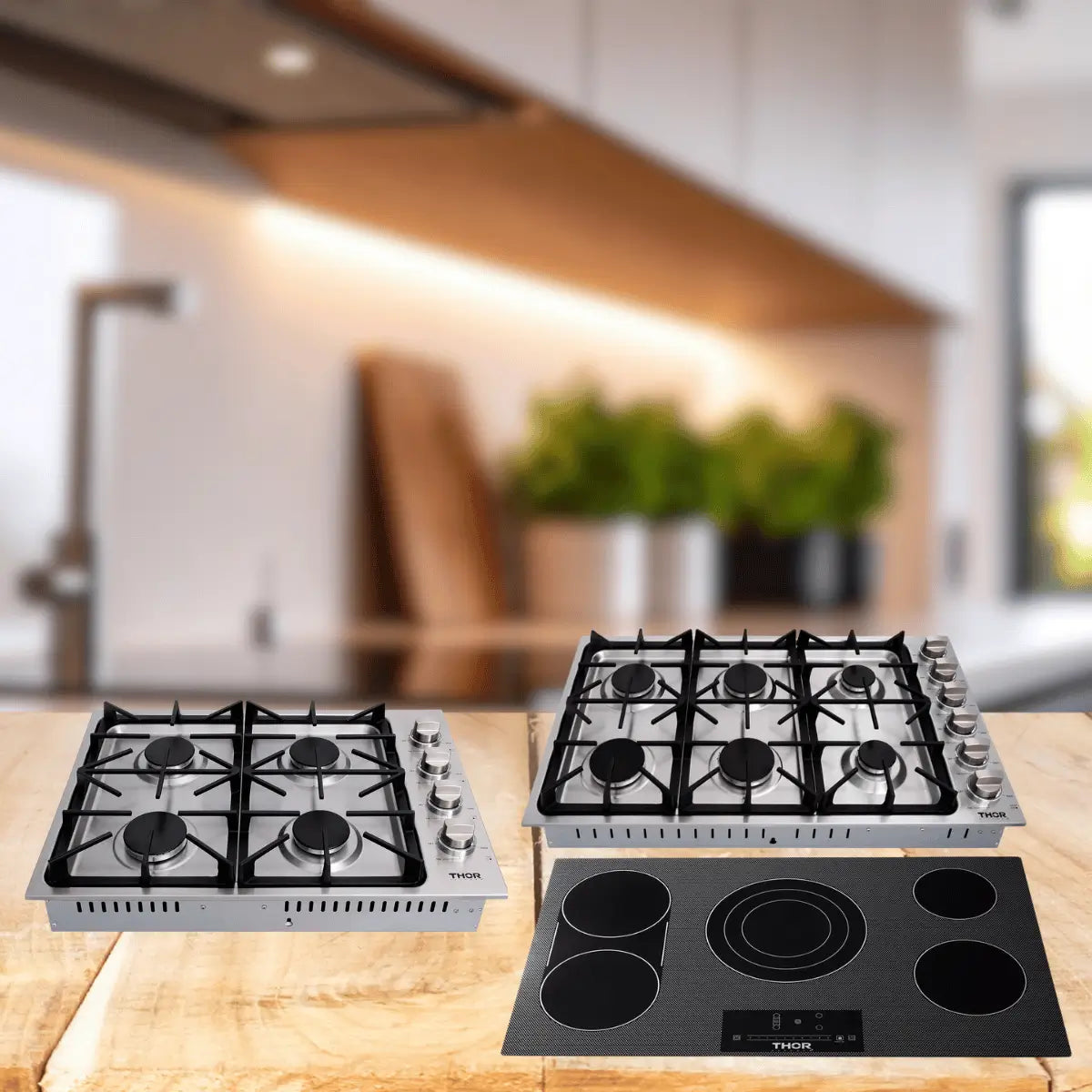 Thor Kitchen cooktops collection featuring stainless steel gas cooktops with multiple burners and a black glass electric cooktop on a modern kitchen countertop.